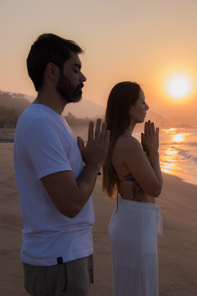 Leandro e Ju em prática de presença diante do mar ao entardecer